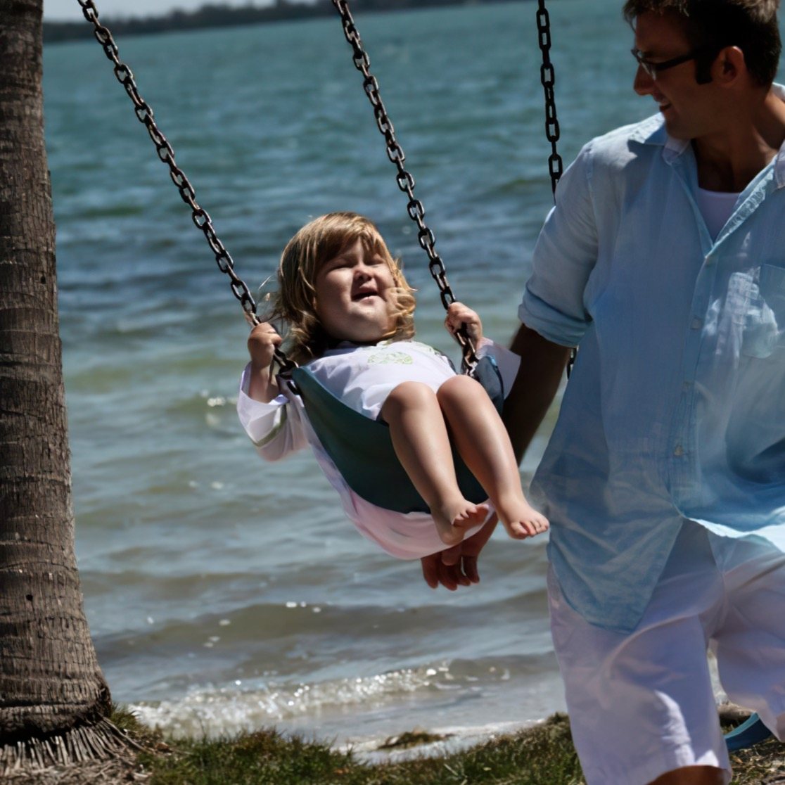 Lilly on a swing as a young child